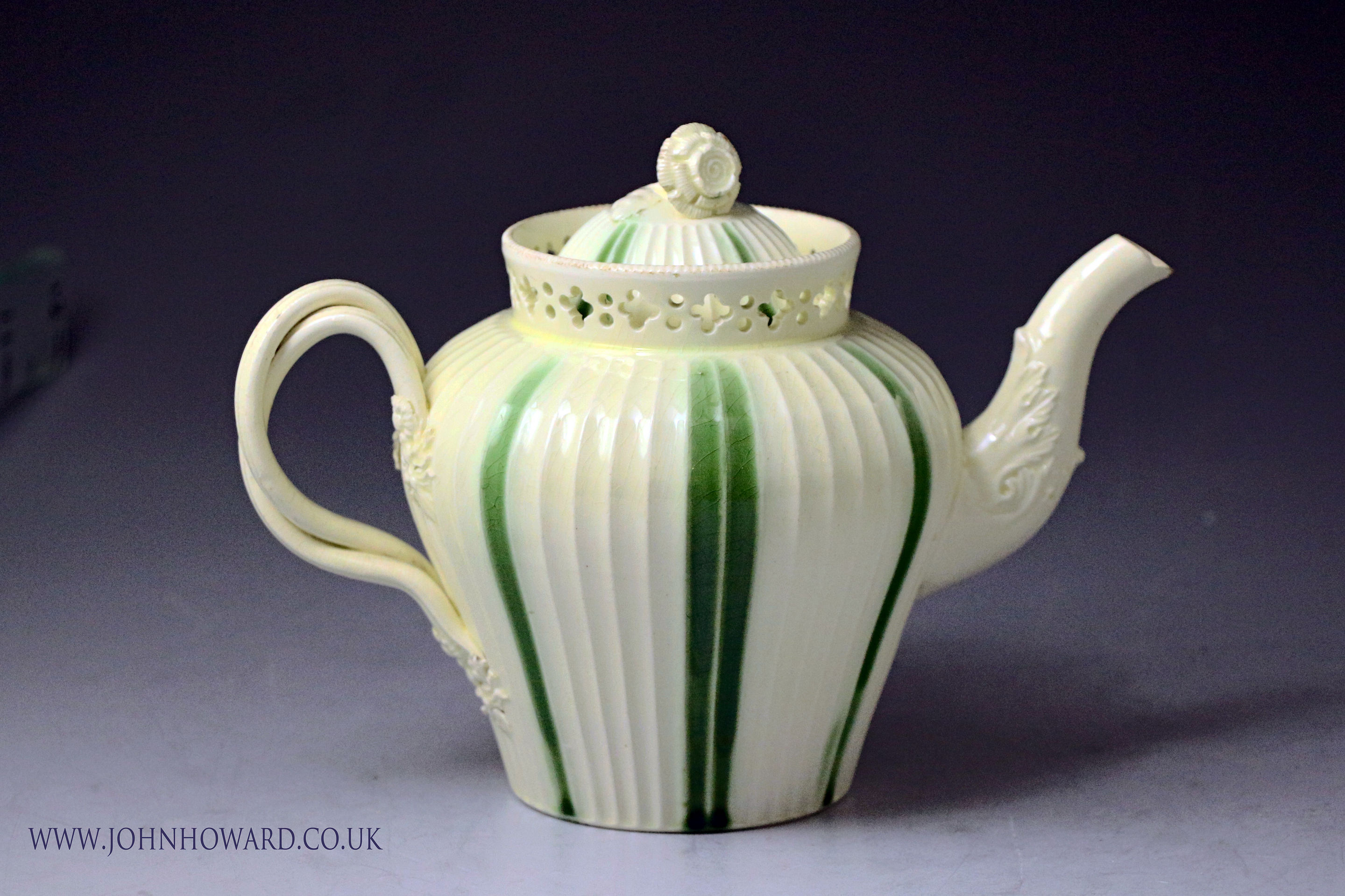 18th century English creamware pottery green striped teapot with reticlated ornamentation .Probably Yorkshire Pottery