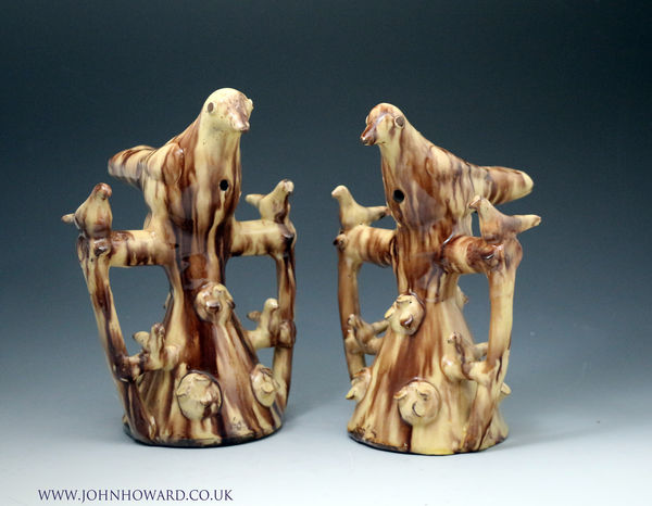 Pair of slipware earthenware whistling bird tree figures English  mid 19th  century