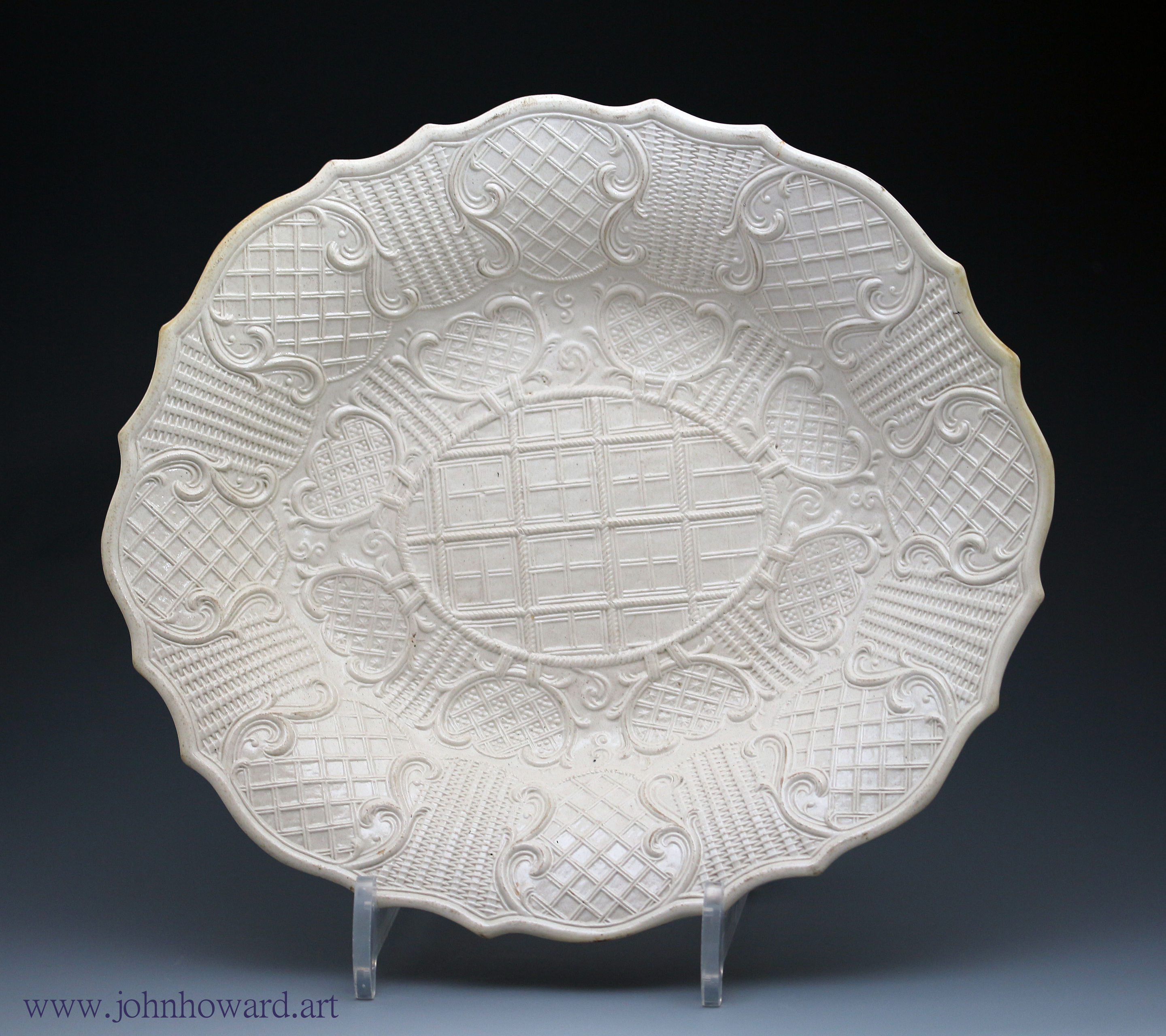 White saltglaze stoneware pottery dish relief molded decoration mid 18th century Staffordshire England