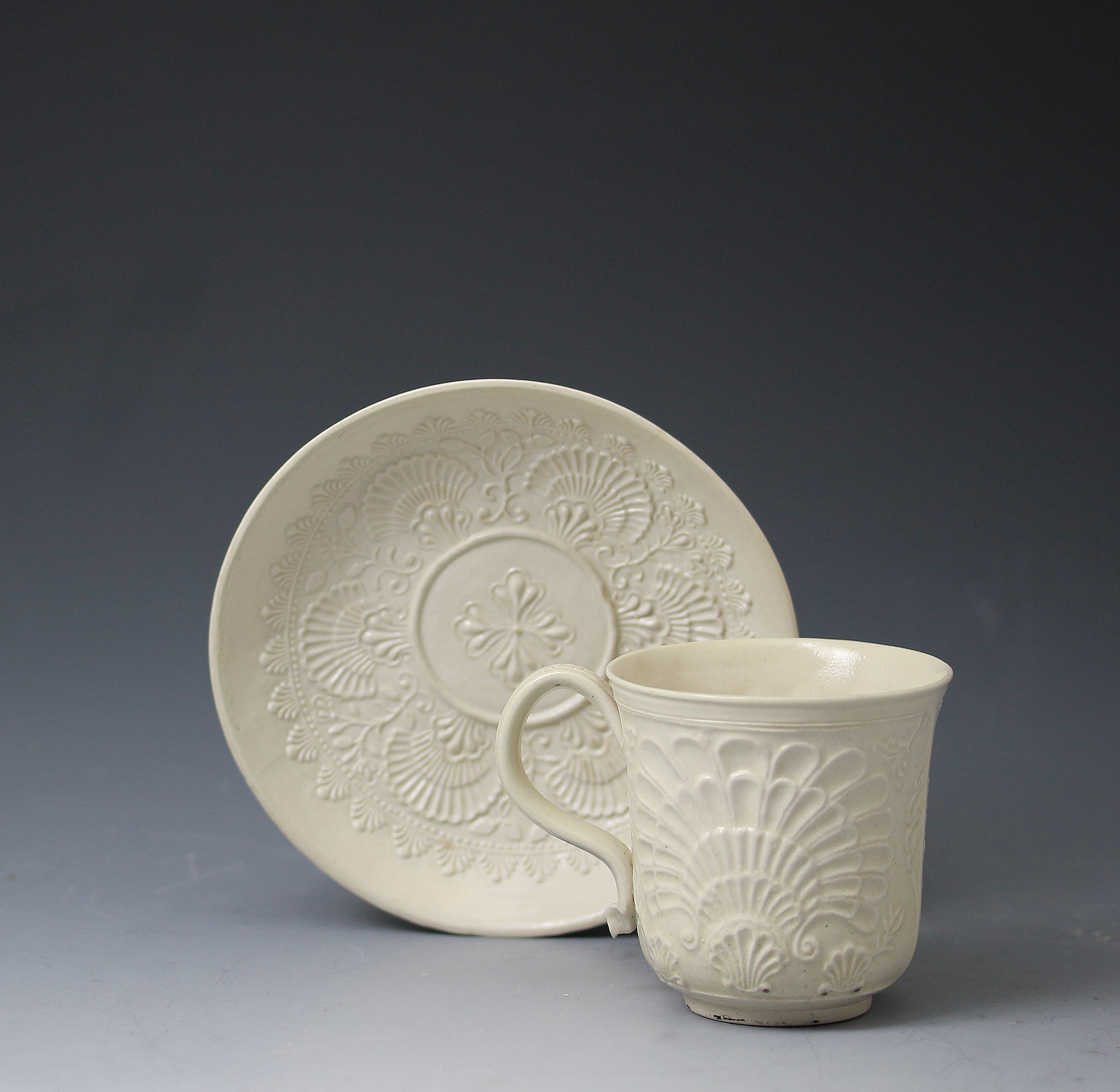 Saltglaze stoneware cup and saucer with pectin decorations relief molded. Staffordshire mid 18thc English