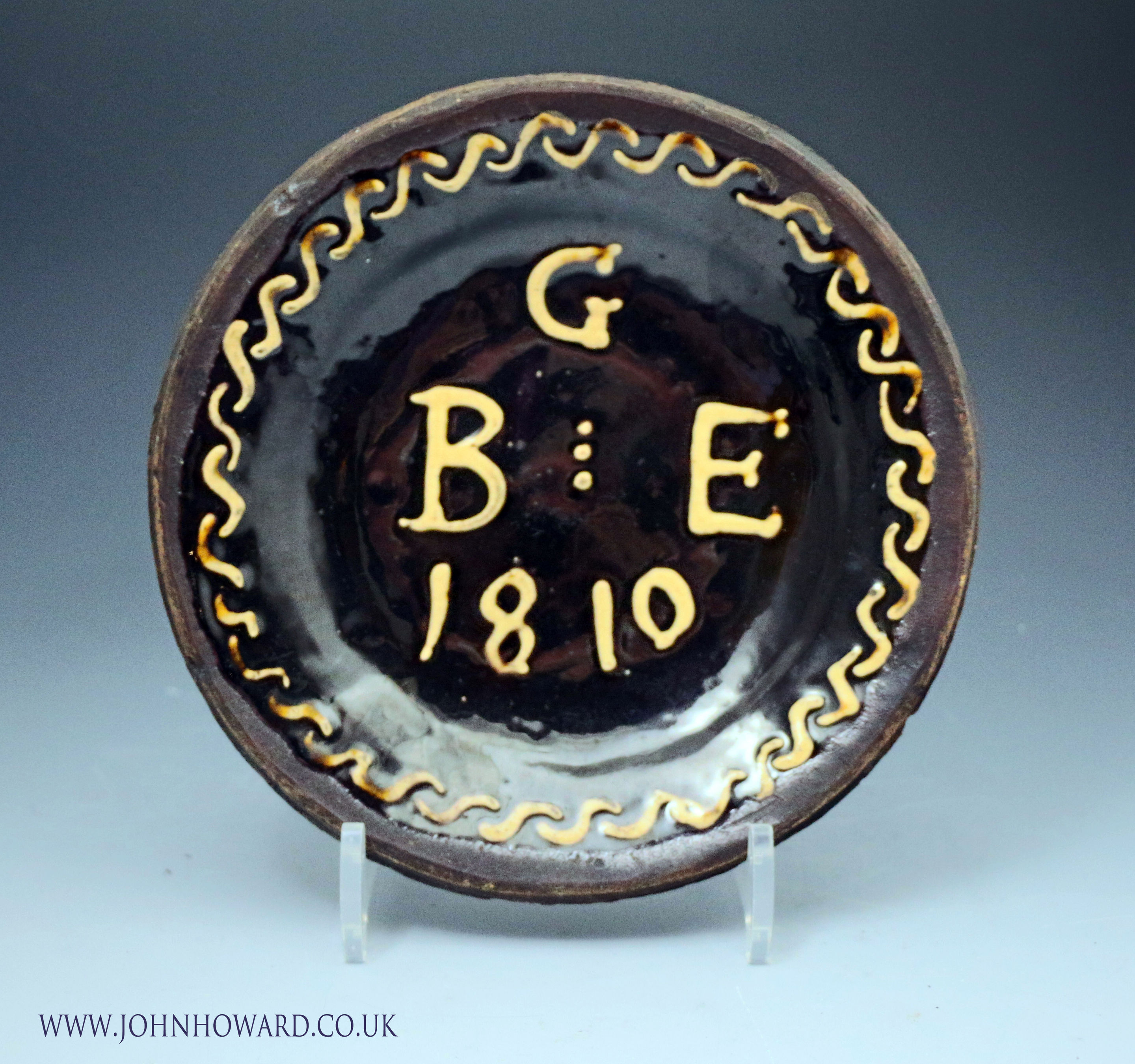 English circular slipware dish initialled G B E with the date 1810