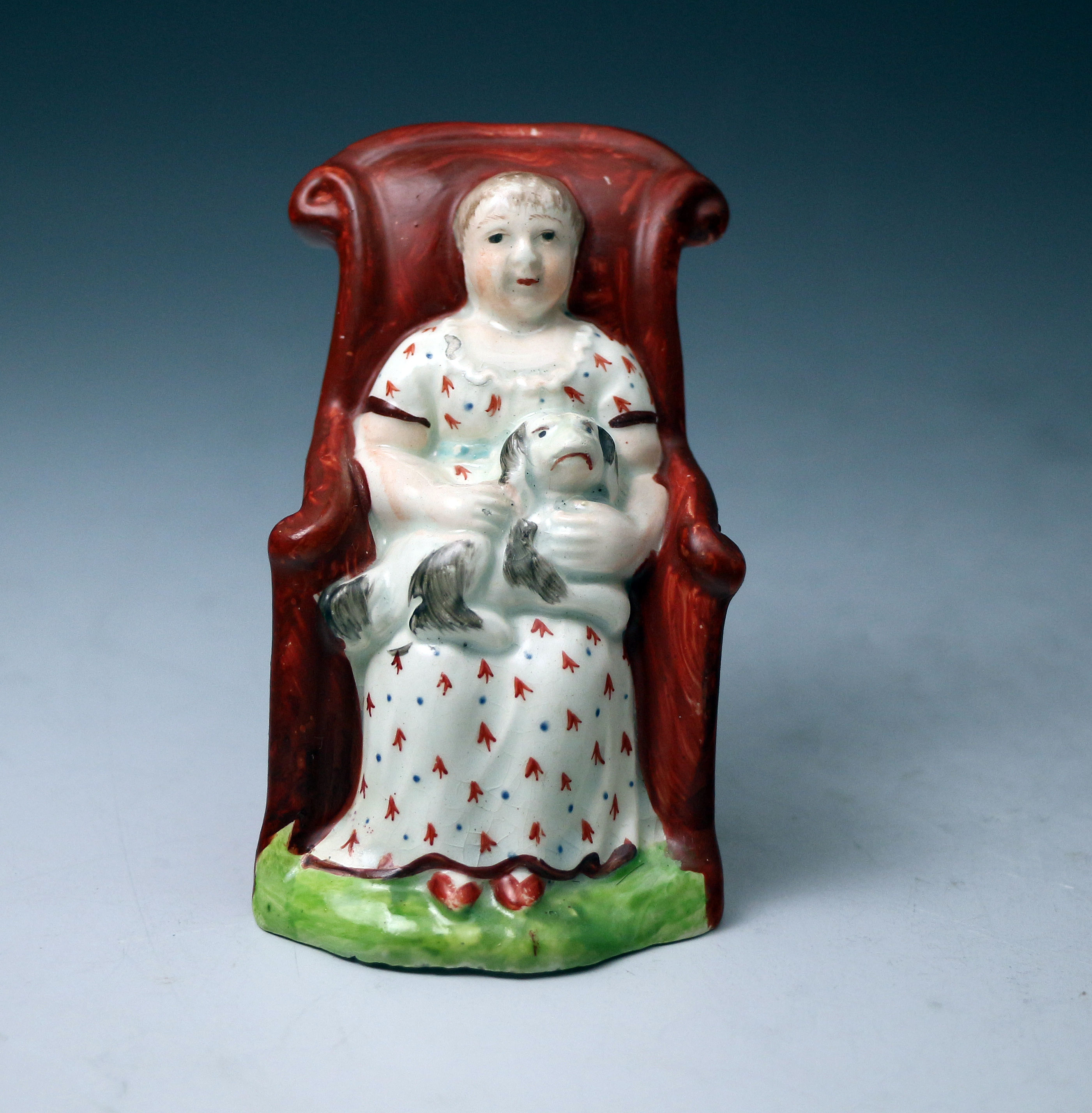 Antique Staffordshire pottery armchair figure with girl and her pet dog circa 1820