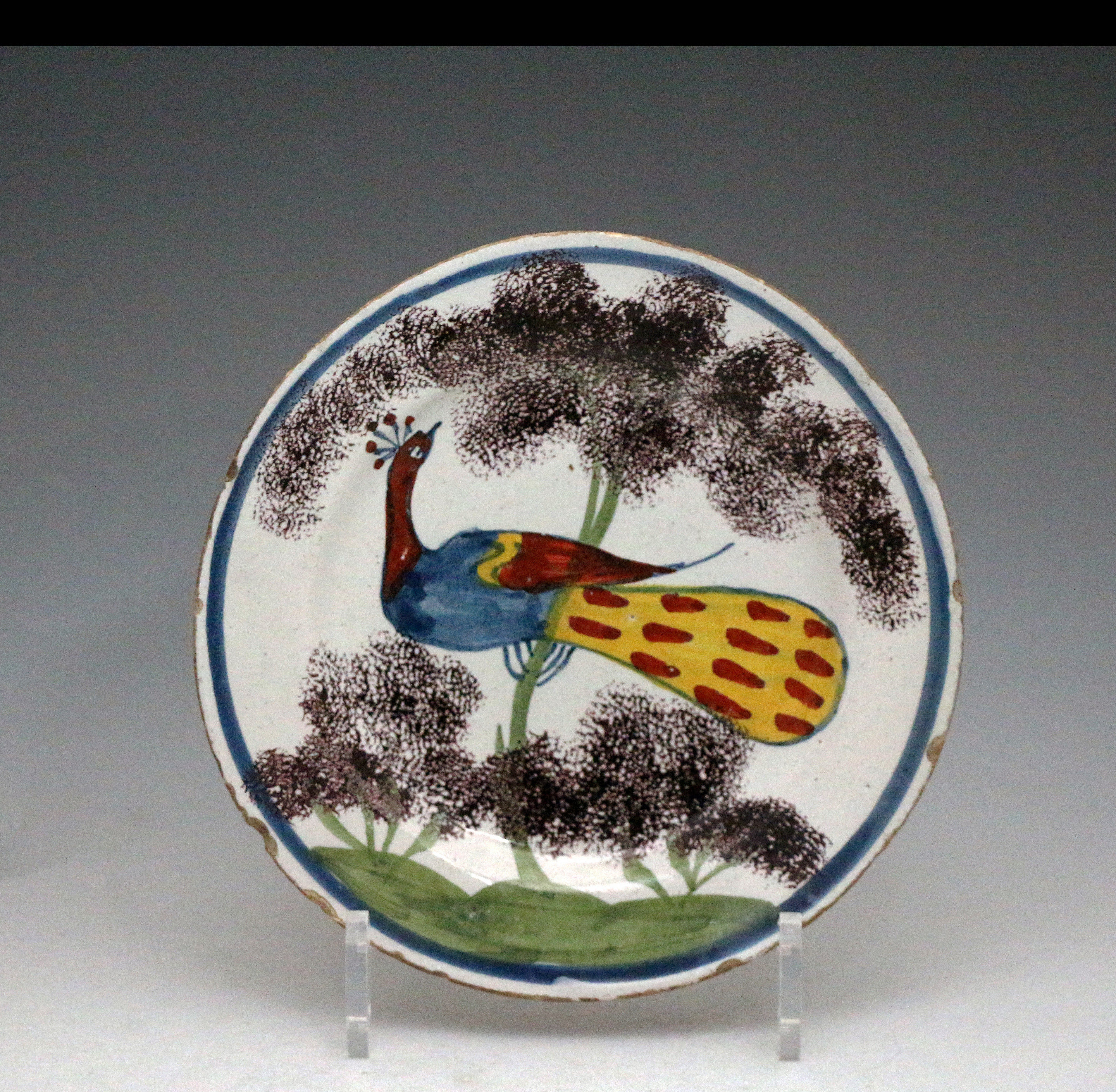 English delftware polychrome decorated peacock farmhouse plate c1735 Bristol delftworks